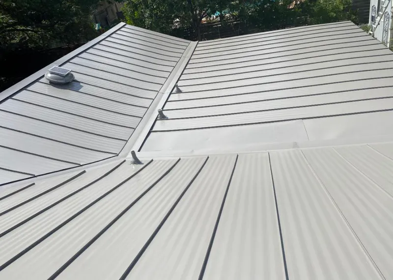 Solar attic fan installed on a metal roof for Roof Ventilation in Winter Garden